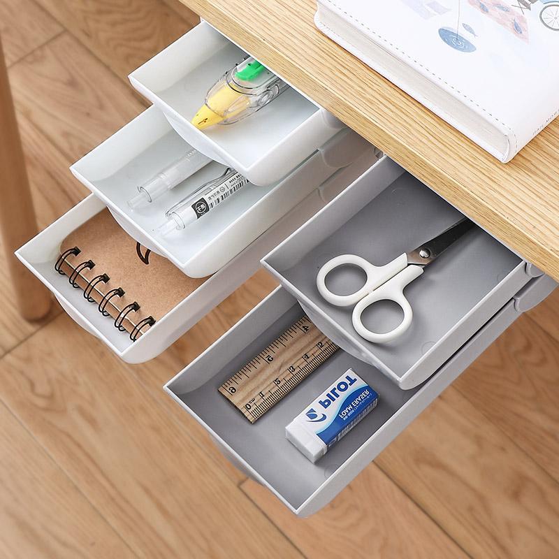 White under-desk hidden drawer organizer holding supplies