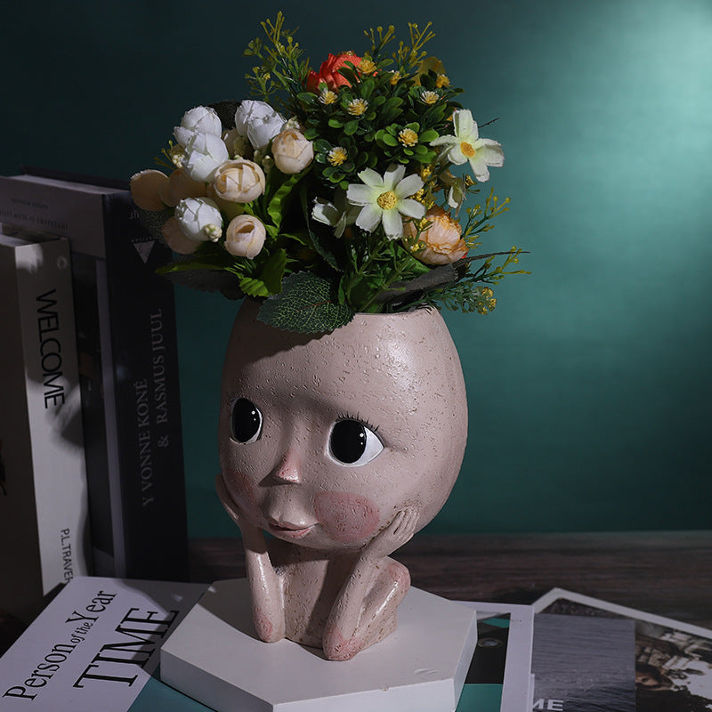 Sculptural face planter with succulent